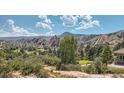 Scenic view of the rolling hills and golf course surrounded by trees and rock formations at 8959 Yellowcress St, Littleton, CO 80125