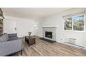 Cozy living room with stone fireplace, large window for natural light, and neutral paint at 17493 E Mansfield Ave # 1231L, Aurora, CO 80013