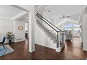 Elegant staircase with hardwood floors, a white and black banister, and abundant natural light at 3074 Castle Butte Dr, Castle Rock, CO 80109
