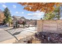 Community entrance gate with stone signage, landscaping, and secure entry system at 6987 Esperanza Dr, Castle Pines, CO 80108