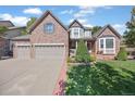 Charming two-story home featuring a manicured lawn, bay window, and attached two-car garage at 6987 Esperanza Dr, Castle Pines, CO 80108