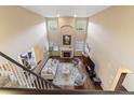 Spacious living room featuring a fireplace, high ceilings, and large windows at 6987 Esperanza Dr, Castle Pines, CO 80108