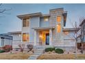 Modern two-story home with stone accents, large windows, and a well-manicured front yard at 15818 W 95Th Ave, Arvada, CO 80007