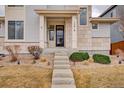 Charming home featuring a welcoming front entrance with stone accents and landscaped pathway at 15818 W 95Th Ave, Arvada, CO 80007