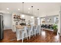 Stylish kitchen with a large center island, modern pendant lighting, and a dining area with ample seating at 3081 Youngheart Way, Castle Rock, CO 80109