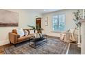 Bright living room featuring a leather sofa, area rug, and modern decor at 3356 Quivas St, Denver, CO 80211