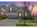 Charming two-story home boasts beautiful stone accents, a well-manicured lawn, and a two-car garage at 24222 E Canyon Pl, Aurora, CO 80016