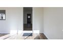 Bright hallway with wood floors leading to the kitchen, offering a view of the kitchen's interior at 1435 Jay St, Lakewood, CO 80214