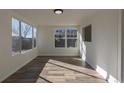 Sunlit living room featuring wood floors and multiple windows at 1435 Jay St, Lakewood, CO 80214