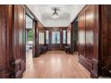 Elegant foyer with hardwood floors, wood paneling, and a decorative chandelier, creating a grand entrance at 685 N Emerson St, Denver, CO 80218