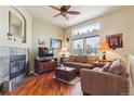 Cozy living room with hardwood floors, fireplace, and ample natural light, creating a warm and inviting atmosphere at 4061 Nordland Trl, Castle Rock, CO 80109