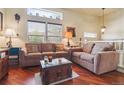 Bright living room with hardwood floors, two couches, and large windows offering plenty of natural light at 4061 Nordland Trl, Castle Rock, CO 80109