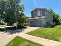 Attractive home featuring a well-maintained lawn and an attached two-car garage at 21300 E 42Nd Ave, Denver, CO 80249