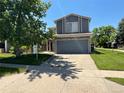 Charming home with a lush front yard and an attached two-car garage at 21300 E 42Nd Ave, Denver, CO 80249