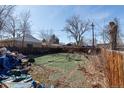 View of a large fenced in backyard needing clean up and some new landscaping at 415 Winona Ct, Denver, CO 80204