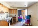 Outdated kitchen needing new appliances and renovation to the cabinets and countertops at 415 Winona Ct, Denver, CO 80204