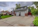 The home features an attached two-car garage and a driveway for additional parking at 66 Yank Way, Lakewood, CO 80228