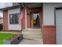 Welcoming front entrance with an American flag and planter at 66 Yank Way, Lakewood, CO 80228