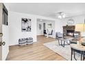 Bright living room features a cozy fireplace and neutral decor at 5225 Beech St, Arvada, CO 80002
