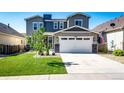 Beautiful two-story home with a well-kept lawn and an attached two-car garage on a sunny day at 3966 Long Rifle Dr, Castle Rock, CO 80108
