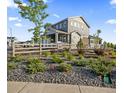 Charming two-story home with stone accents, a landscaped yard, and a delightful wooden fence at 8486 Cheraw St, Littleton, CO 80125