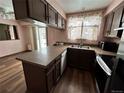 L-shaped kitchen with stainless steel appliances and a view of the backyard at 17422 E Progress Dr, Centennial, CO 80015