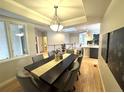 Elegant dining room with tray ceiling, skylight, and modern furnishings at 22148 Red Hawk Ln, Golden, CO 80401