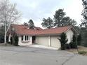Charming ranch-style home with red tile roof and three-car garage at 22148 Red Hawk Ln, Golden, CO 80401
