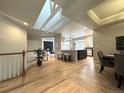 Open-concept living area featuring hardwood floors, skylights, and modern design at 22148 Red Hawk Ln, Golden, CO 80401