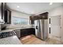 Spacious kitchen featuring stainless steel appliances, granite countertops, and ample cabinet space at 56432 E 23Rd Ave, Strasburg, CO 80136