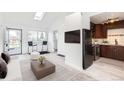 Bright, modern living room featuring a breakfast bar and sleek dark appliances at 1533 Xenia St, Denver, CO 80220