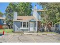 Inviting home exterior with a front porch, manicured lawn, and convenient parking spaces at 8168 Washington St # 46, Denver, CO 80229
