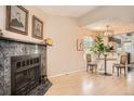 Cozy living room featuring a fireplace, hardwood floors, and an adjacent dining area at 8168 Washington St # 46, Denver, CO 80229