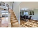 Elegant dining room with hardwood floors, staircase, and natural light at 10984 Alcott Dr, Denver, CO 80234