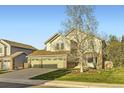 Beautiful two-story home with a three-car garage and a well-maintained lawn at 10984 Alcott Dr, Denver, CO 80234