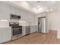Modern kitchen equipped with stainless steel appliances, sleek cabinetry, and hardwood floors at 2876 W 53Rd Ave # 122, Denver, CO 80221