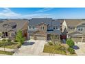 Expansive aerial view of a two-story home with stone accents, three-car garage, and well-maintained lawn at 14997 Elsinore Ave, Parker, CO 80134