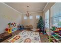 Spacious playroom with hardwood floors, bright windows, and fun, colorful decor at 14997 Elsinore Ave, Parker, CO 80134