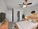 Comfortable bedroom with a ceiling fan, closet, and a neutral color palette at 8632 Yule St, Arvada, CO 80007