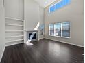 Bright living room boasts high ceilings, a fireplace, and lots of natural light at 8632 Yule St, Arvada, CO 80007