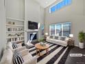Bright living room boasts high ceilings, a fireplace, and a decorative black and white rug at 8632 Yule St, Arvada, CO 80007