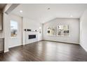 Bright living room with vaulted ceilings, hardwood floors, and a cozy fireplace at 2501 Lupton Ln, Lafayette, CO 80026