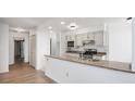 Open kitchen featuring stainless steel appliances and stone countertops at 1625 Larimer St # 1001, Denver, CO 80202