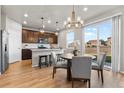 Bright eat-in kitchen with dark cabinetry, granite counters, stainless appliances and access to backyard via sliding glass door at 18014 Tree Sparrow Ave, Parker, CO 80134