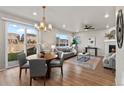 Open floor plan shows living room and dining area with sliding glass doors to the backyard at 18014 Tree Sparrow Ave, Parker, CO 80134