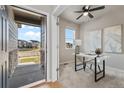 Bright office space with a modern desk and a view of the front yard at 18014 Tree Sparrow Ave, Parker, CO 80134