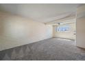 Unfurnished living room featuring neutral-toned walls and carpet and a ceiling fan at 6800 E Tennessee Ave # 452, Denver, CO 80224