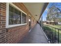 Outdoor patio with brick facade, a metal railing and a lovely view at 6800 E Tennessee Ave # 452, Denver, CO 80224