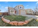 Charming two-story home with a well-manicured lawn and mature landscaping at 180 S Carlton St, Castle Rock, CO 80104