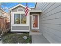 Charming home exterior featuring gray siding, a red door, and American flag waving at 180 S Carlton St, Castle Rock, CO 80104